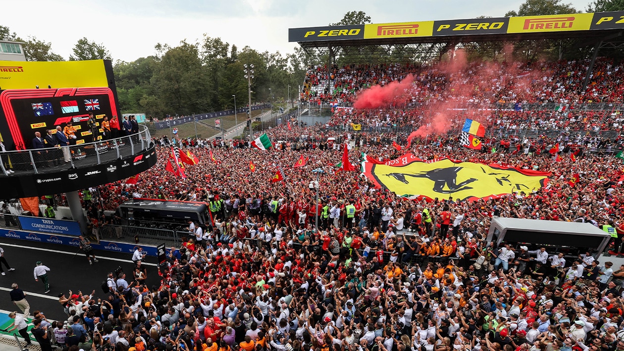 Charles Leclerc on the Monza podium in front of massed ferrari fans at the 2024 F1 Italian Grand Prix