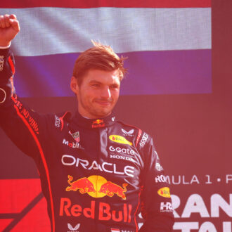 Max Verstappen raises fist on podium after winning the 2025 F1 Italian Grand Prix for Red Bull