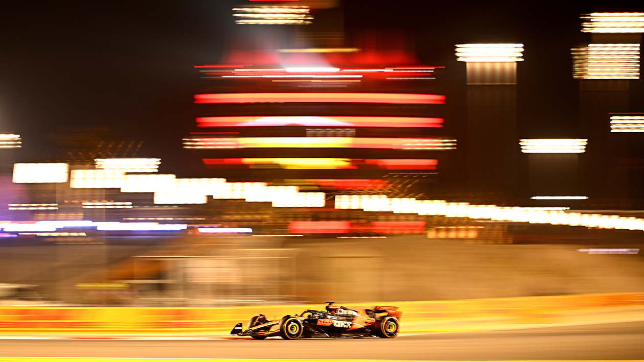 Lights blurred in background of Oscar Piastri in 2025 F1 Bahrain Grand Prix