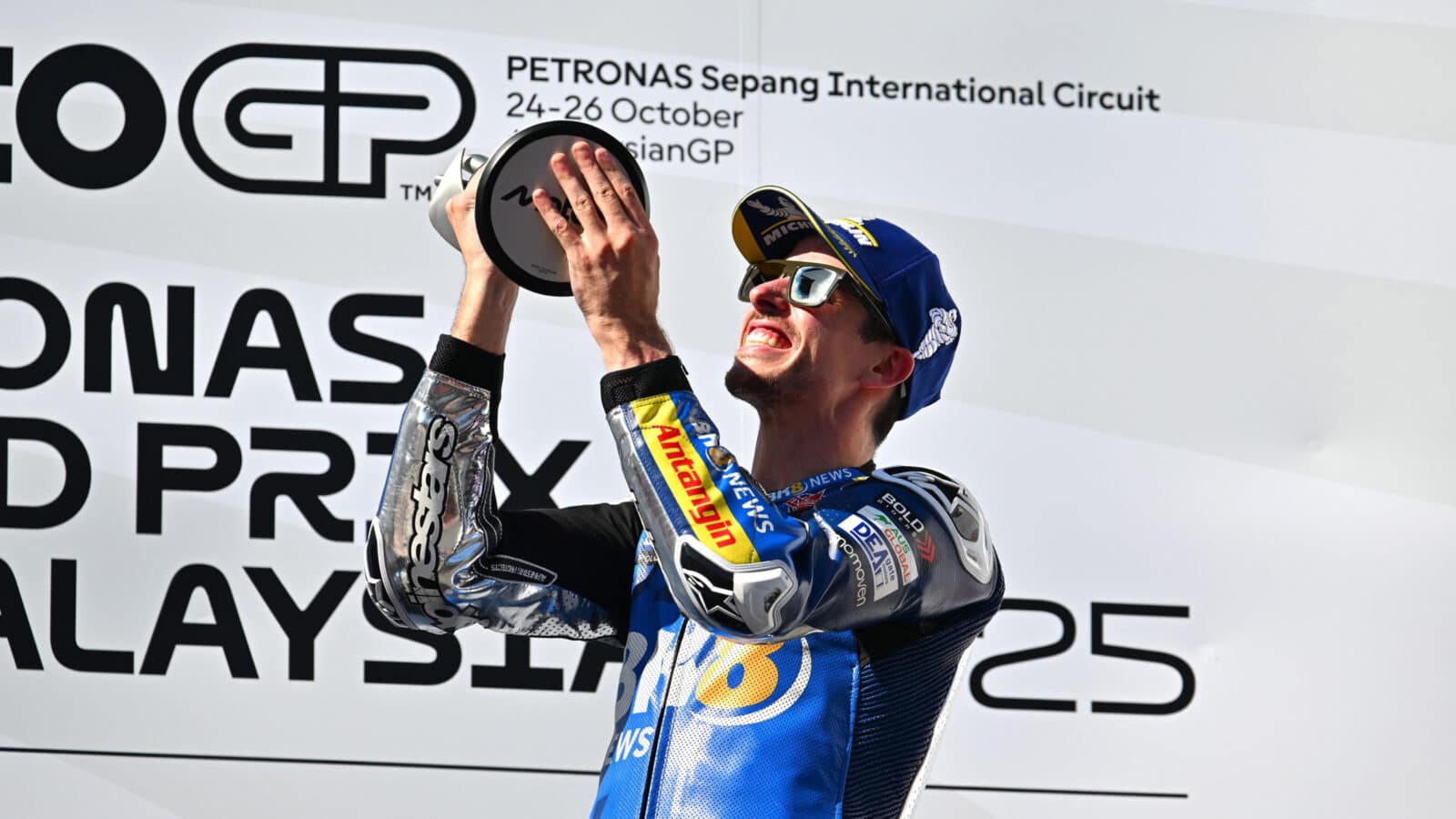 Alex Marquez celebrates victory on the podium at the 2025 MotoGP Malaysian GP