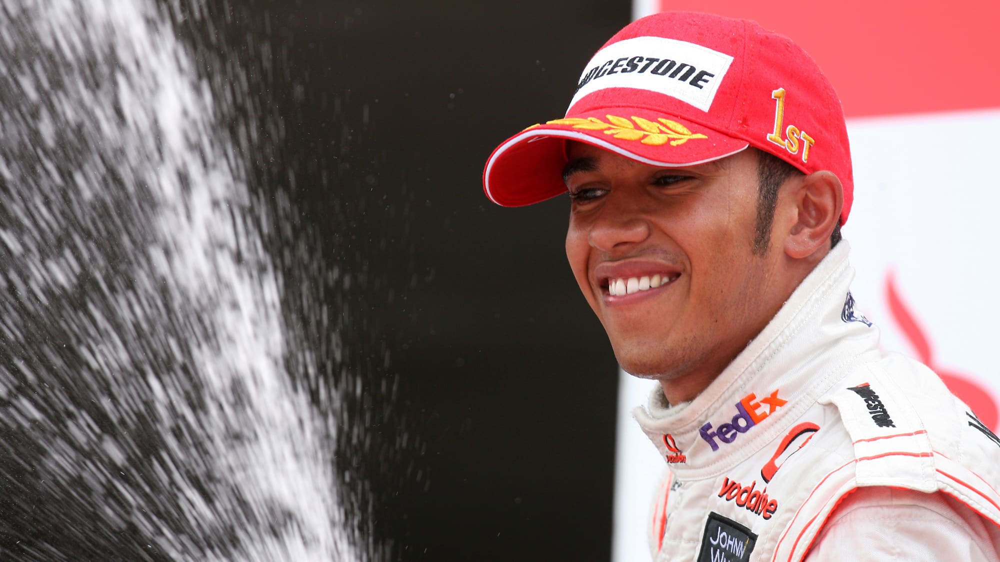 Lewis Hamilton sprays champagne after winning the 2008 British Grand Prix