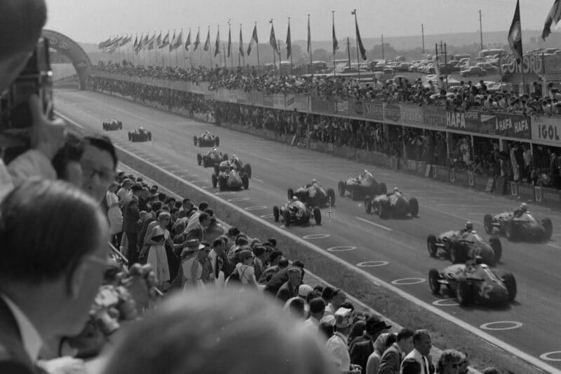 Gerino Gerini (Maserati 250F) Chico Godia-Sales, (Maserati 250F) and Jo Bonnier (Maserati 250F) follow after the rest of the field at the start of the race.