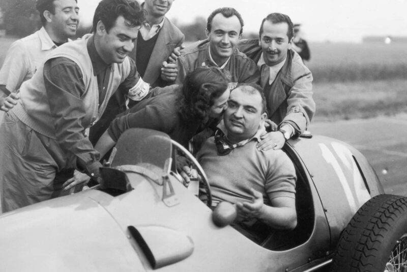 14th July 1951: Jose Frolien Gonzalez is kissed by his wife after winning the British Grand Prix at Silverstone in his Ferrari 375. (Photo by Douglas Miller/Keystone/Getty Images)