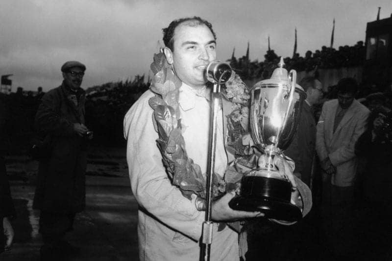 17th July 1954: Argentinian driver Jose Froilan Gonzalez with his Grand Prix trophy after a win at Silverstone.