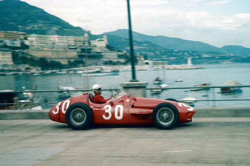 Maserati's Behra makes his way past the harbour