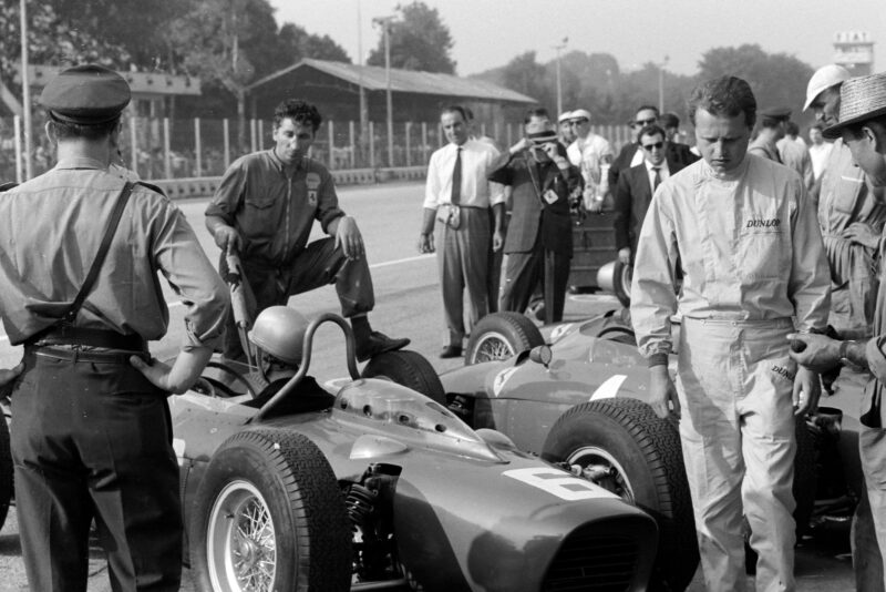 Bandini prepares to leave the Ferrari pit as team-mate Baghetti walks by