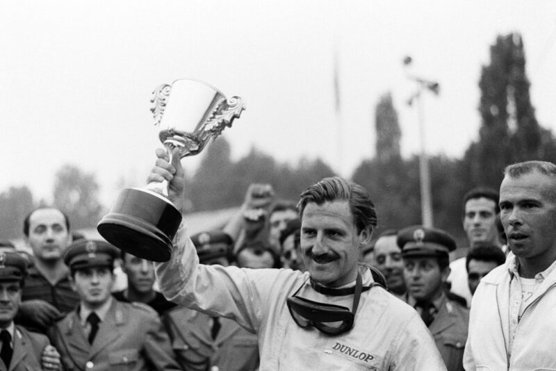 Hill lifts the winner's trophy for the third time that season