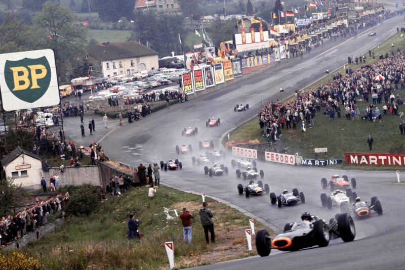 Graham Hill leads Jackie Stewart (Both BRM P261's), Richie Ginther (Honda RA272), Jo Siffert (Brabham BT11 BRM), John Surtees (Ferrari 158), Dan Gurney (Brabham BT11 Climax) and the rest of the field through Eau Rouge at the start.