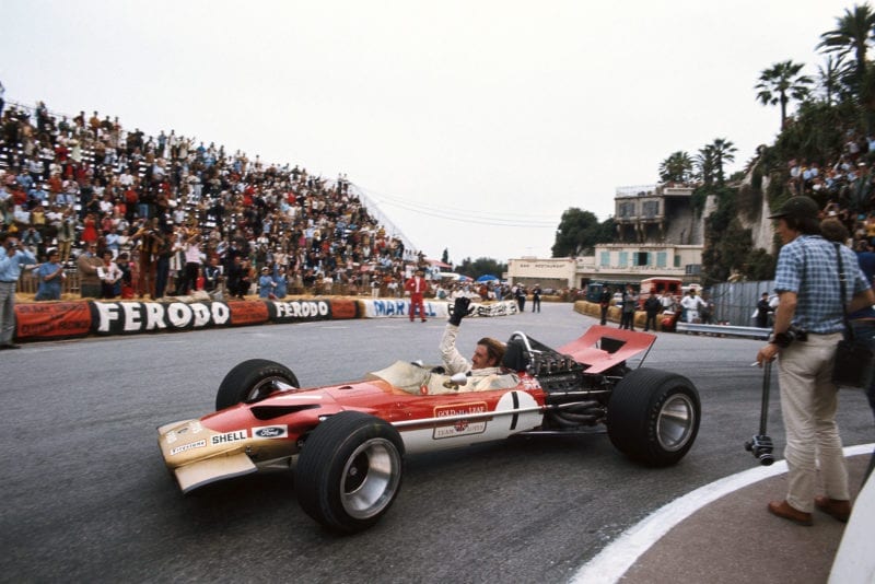 Graham Hill waves to the crowd after sealing victory