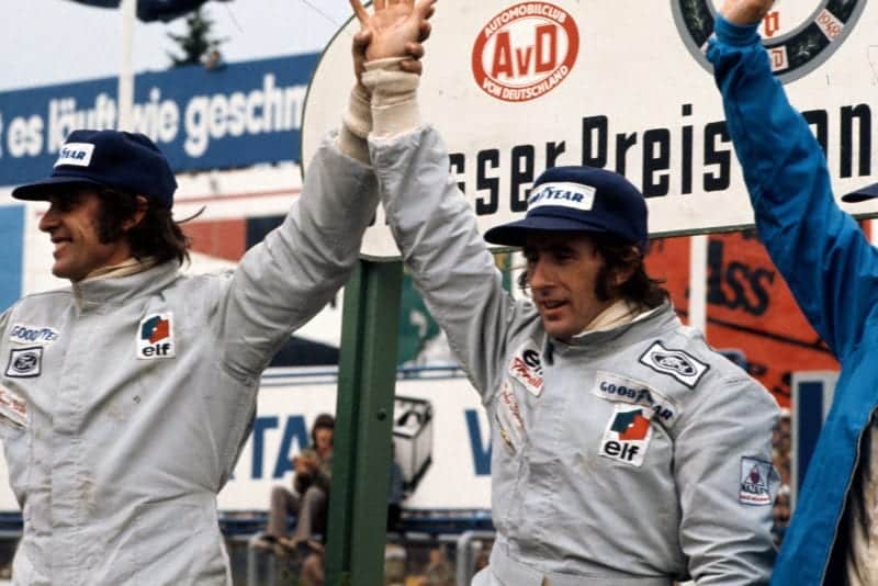Tyrell drivers Francois Cevert (left) and Jackie Stewart celebrate on the podium.