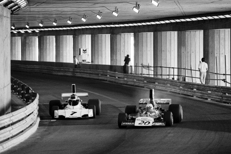 Carlos Reutemann challenges Arturo Merzario in the tunnel during the 1974 Monaco Grand Prix.