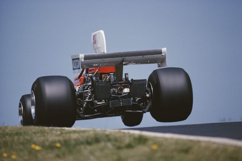 Mark Donahue (Penske) takes off down the Flugplatz at the 1975 German Grand Prix, Nurburgring.