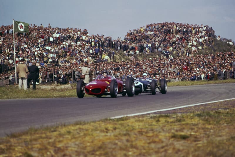 Richie Ginther in a Ferrari Dino 156) leads Stirling Moss in his Lotus 18-Climax.