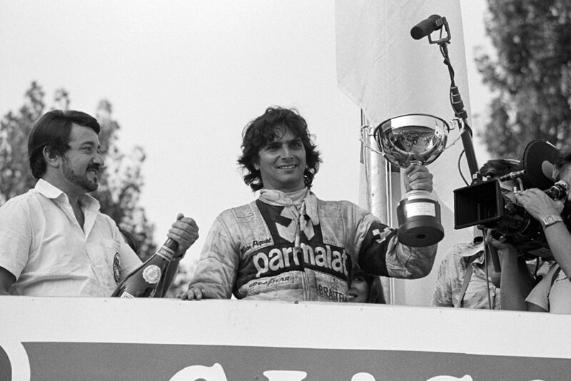 Race winner Nelson Piquet celebrates on the podium.