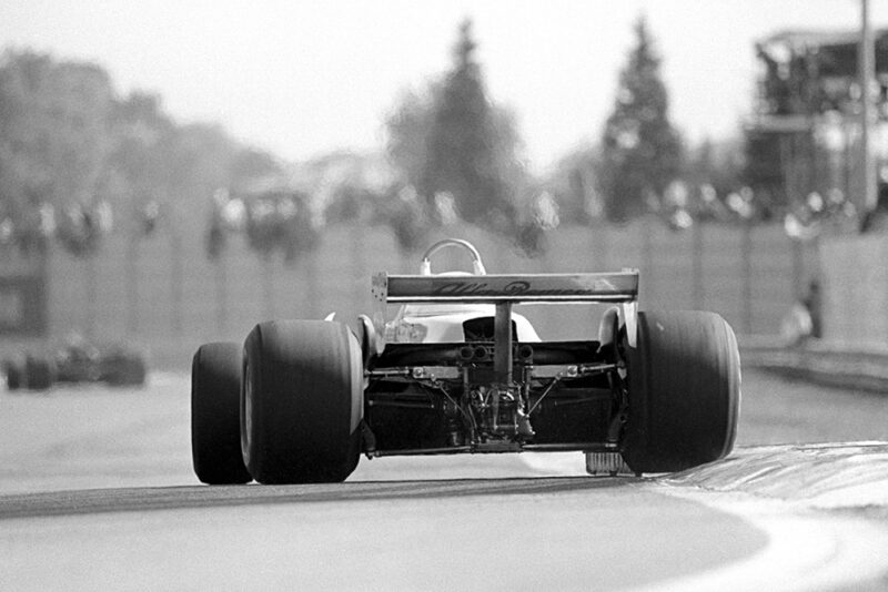 An Alfa Romeo 179 rides the kerb exiting the Variante Alta.