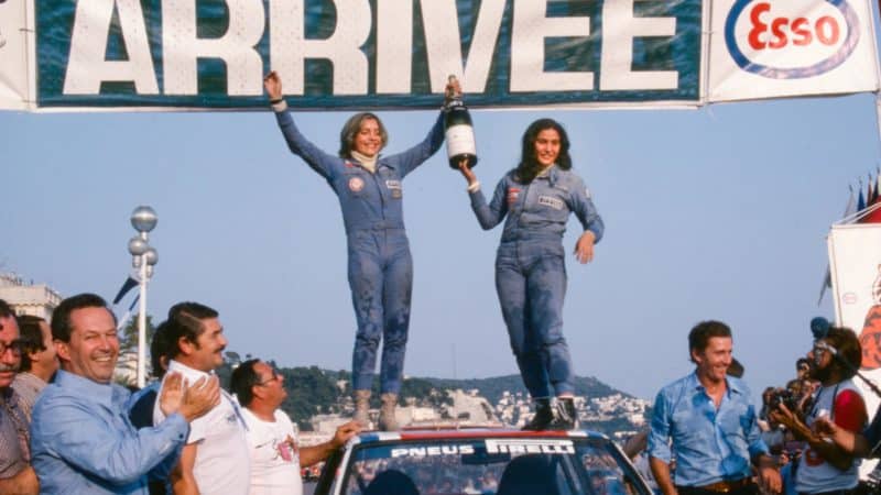 Michele Mouton and Francoise Conconi hold a bottle of champagne on the roof of their Fiat 131 Abarth