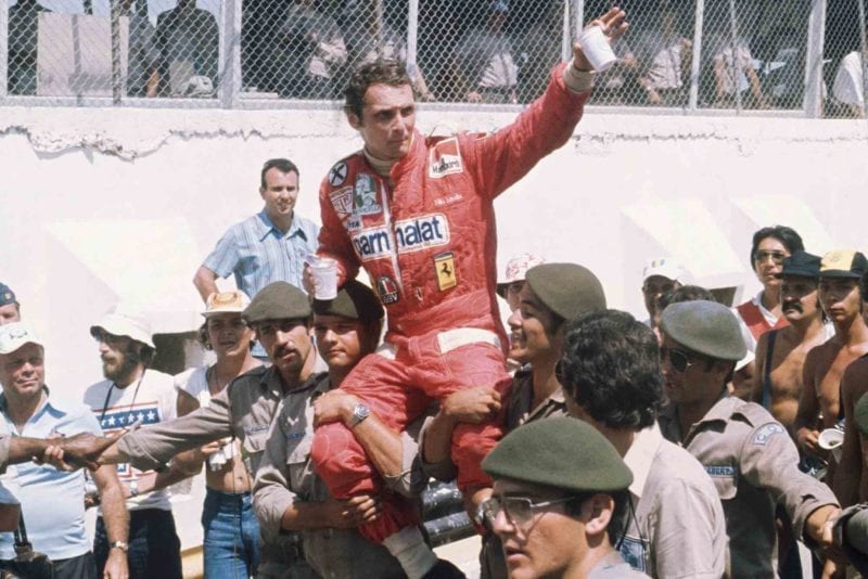Niki Lauda is held aloft by Brazilian soldiers after winning the 1976 Brazilian Grand Prix for Ferrari