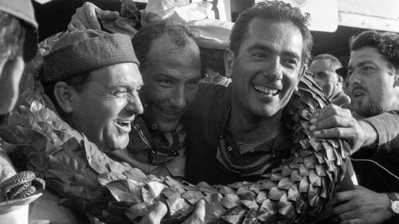 Jean Behra and Stirling Moss wearing garland after winning 1957 Swedish Grand Prix