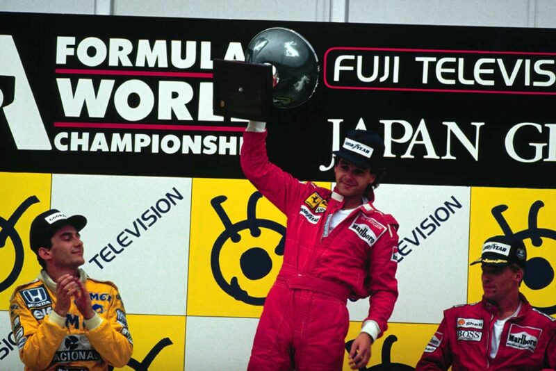 On the podium at Suzuka, Japan, Gerhard Berger, Ayrton Senna and Stefan Johansson celebrate finishing in 1st, 2nd and 3rd positions respectively.