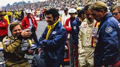 Mark Donohue jokes around before the race with a mechanic, next to Bobby Unser and Dan Gurney ahead of the 1973 Indianapolis 500