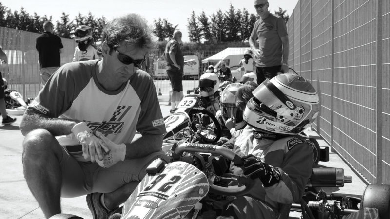 Jarno Trulli speaking to his son in a go kart