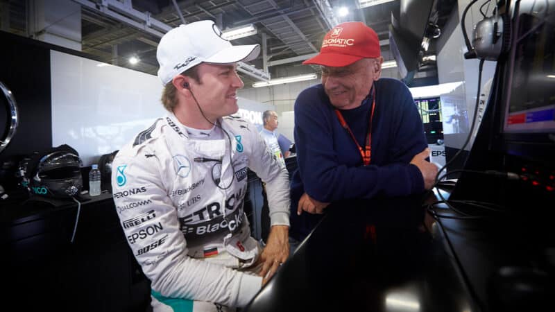 Niki Lauda talks with Nico Rosberg in Mercedes F1 pit garage
