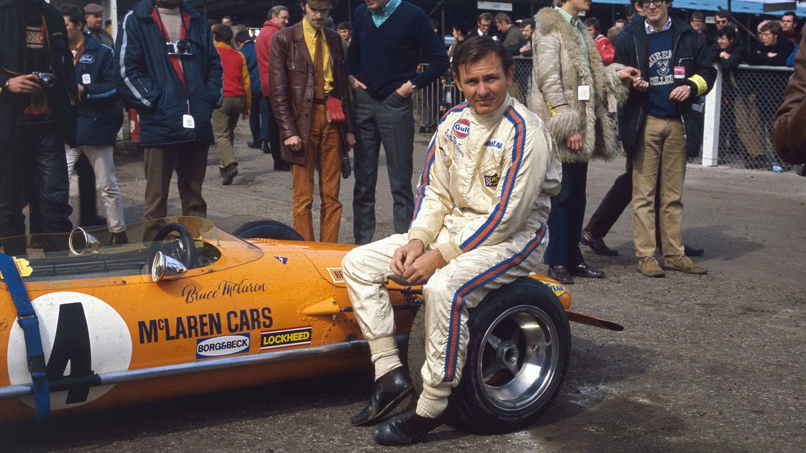 March 1970: New Zealand motor-racing driver Bruce McLaren (1937 - 1970) sits on the wheel of his McLaren-Ford M14A before the start of the Race of Champions at Brands Hatch in Kent. (Photo by Fox Photos/Getty Images)
