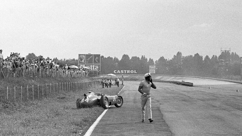 Eugenio Castellotti walks away from his Lancia-Ferrari in 1956 Italian Grand Prix