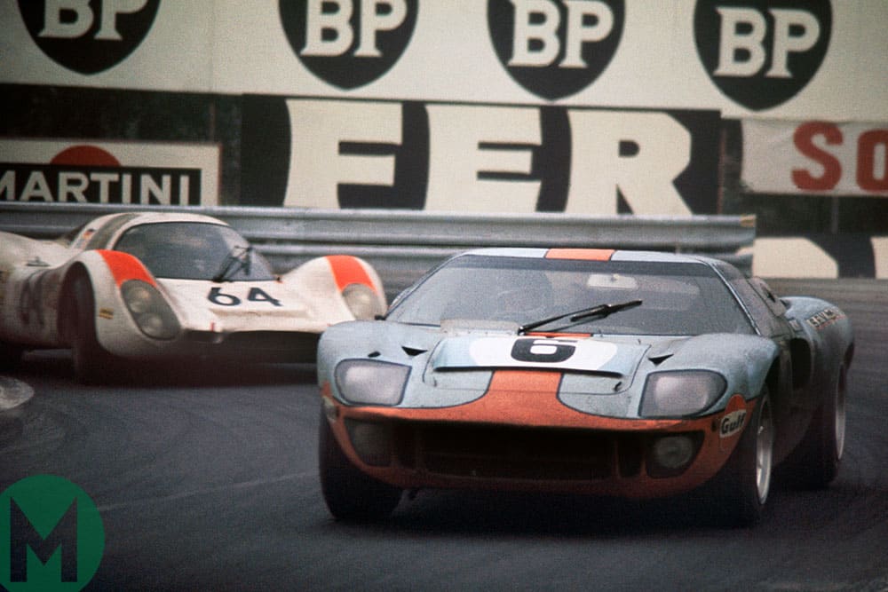 Jacky Ickx/Jackie Oliver's Ford GT40 leads Hans Herrmann/Gérard Larrousse's Porsche 908 at the 1969 Le Mans 24 Hours