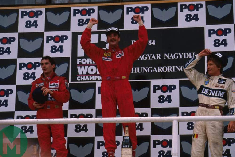 Mansell celebrates on the podium, flanked by Ayrton Senna and Thierry Boutsen