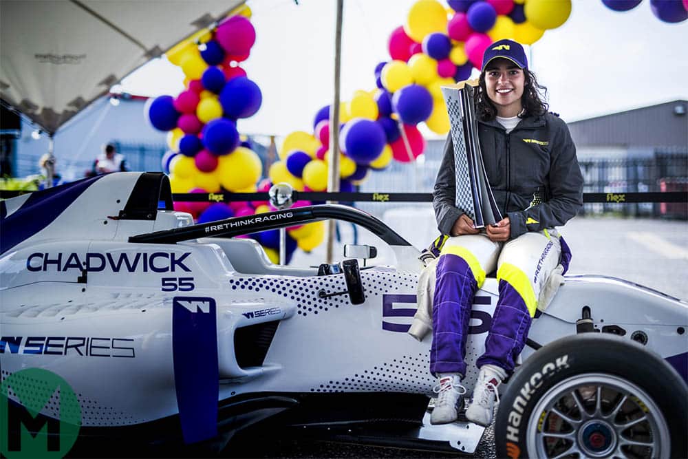 Jamie Chadwick holds the W Series championship trophy at Brands Hatch