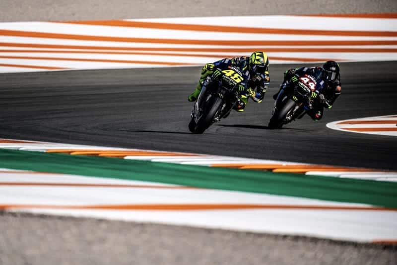 Lewis Hamilton and Valentino Rossi ride side by side on Yamaha MotoGP bikes
