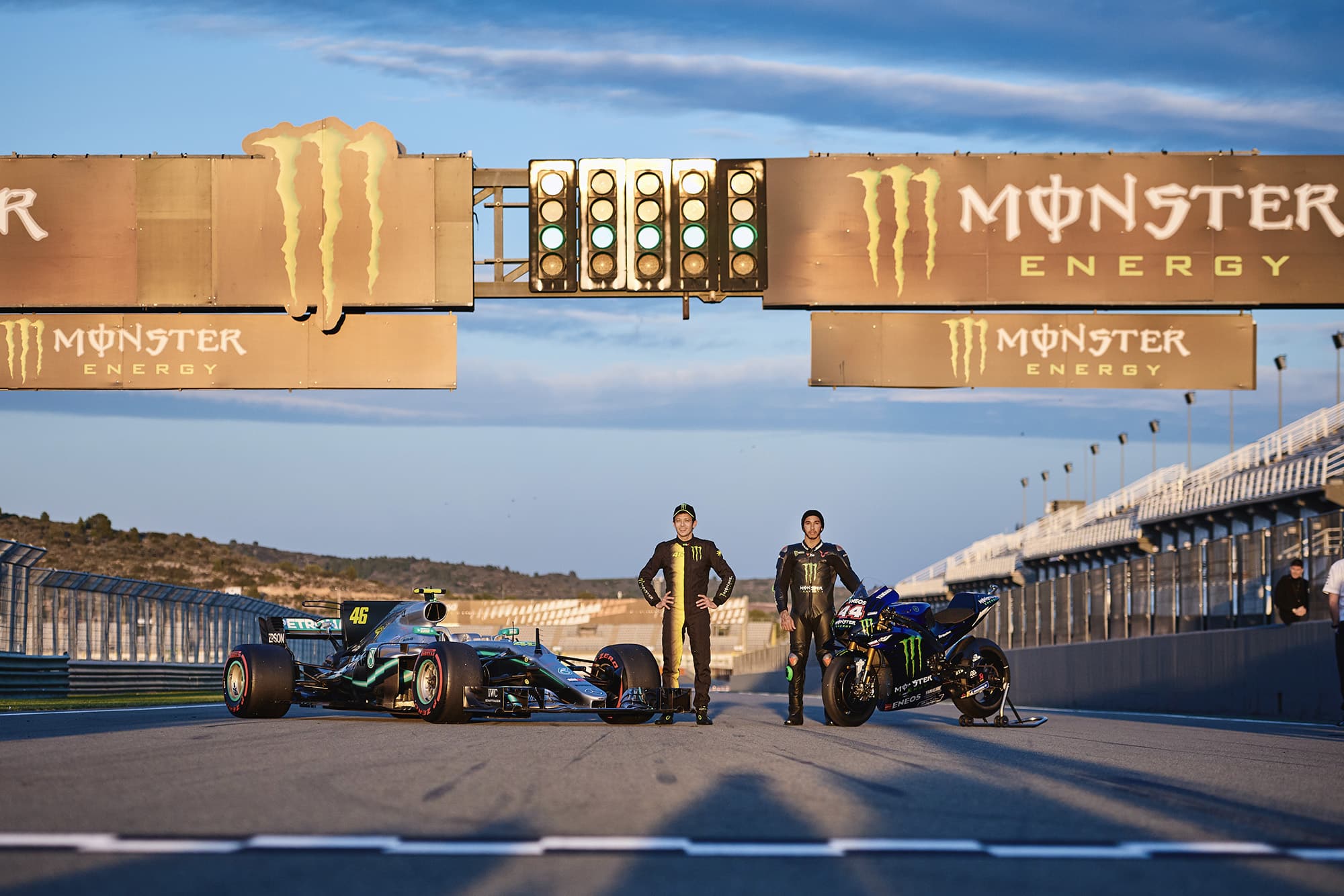 Lewis Hamilton and Valentino Rossi pose in front of the 2019 Yamaha M1 and 2017 Mercedes W08