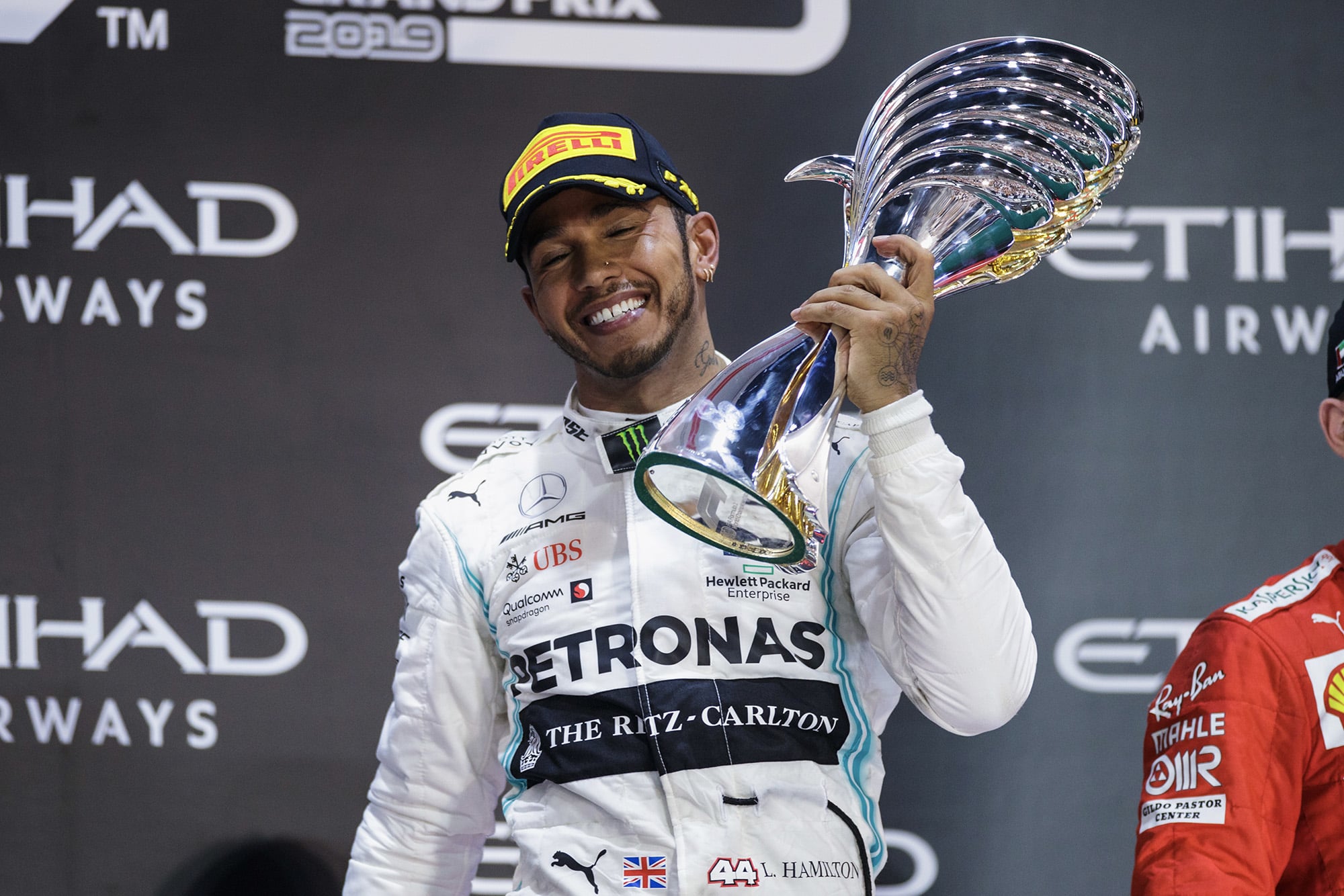 Lewis Hamilton smiles with the race-winning trophy from the 2019 F1 Abu Dhabi Grand Prix
