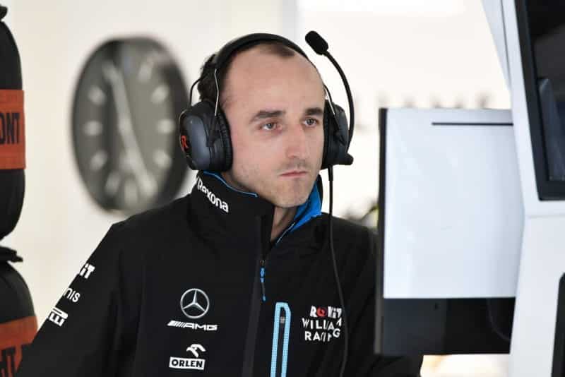 Robert Kubica in front of a monitor in the F1 pits