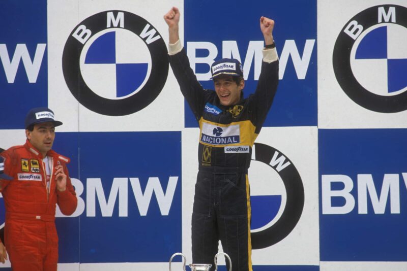 Ayrton Senna celebrates his first race victory in the 1985 Portuguese Grand Prix