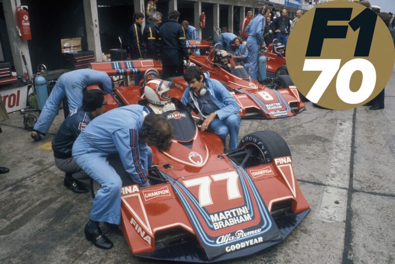 Gordon Murray speaks to Rolf Stommelen in his Brabham BT45 in the pits at the 1976 German Grand Prix