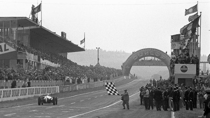 Jack Brabham takes the chequered flag to win in the 1960 French Grand Prix at Reims