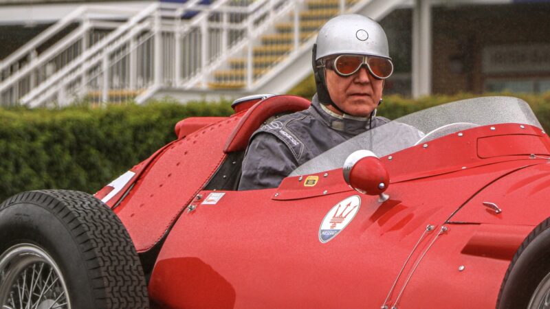 Rick Hall wearing Juan Manuel Fangio's goggles worn in the 1955 British Grand Prix at Aintree