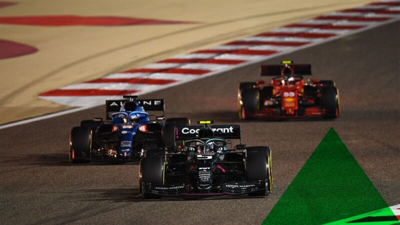 BAHRAIN, BAHRAIN - MARCH 28: Sebastian Vettel of Germany driving the (5) Aston Martin AMR21 Mercedes leads Fernando Alonso of Spain driving the (14) Alpine A521 Renault and Carlos Sainz of Spain driving the (55) Scuderia Ferrari SF21 on track during the F1 Grand Prix of Bahrain at Bahrain International Circuit on March 28, 2021 in Bahrain, Bahrain. (Photo by Clive Mason - Formula 1/Formula 1 via Getty Images)