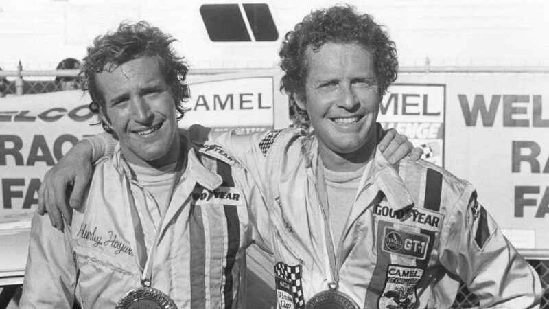 DAYTONA BEACH, FL — Mid-1970s: Peter Gregg (L) and Hurley Haywood (R) co-drove a Porsche 911 to victory in the 24 Hours of Daytona at Daytona International Speedway in both 1973 and 1975. (Photo by ISC Images & Archives via Getty Images)