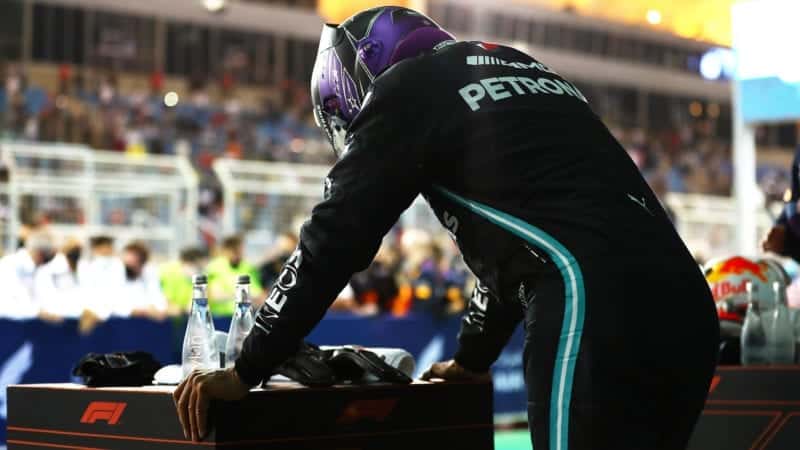 Lewis Hamilton leans on a stand after winning the 2021 Bahrain Grand Prix