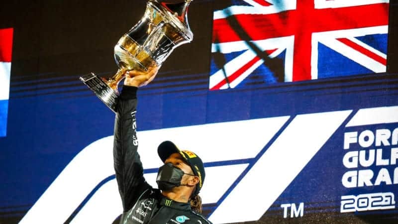 Lewis Hamilton lifts the winners trophy from the 2021 Bahrain Grand Prix
