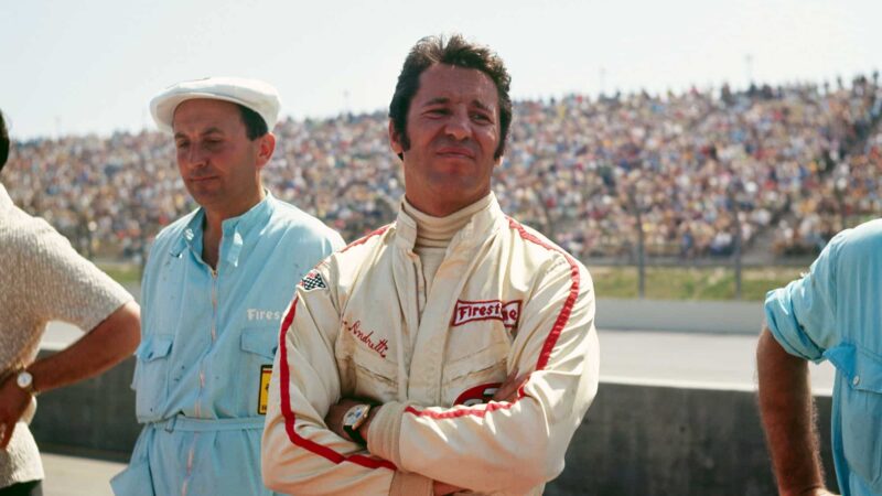 UNITED STATES - MARCH 30: 1971 Questor Grand Prix. Race winner Mario Andretti of Scuderia Ferrari stands by the pits with crew members. Andretti drove the Ferrari 312B to a race victory after starting the race twelfth on the grid. (Photo by John Lamm/The Enthusiast Network via Getty Images/Getty Images)