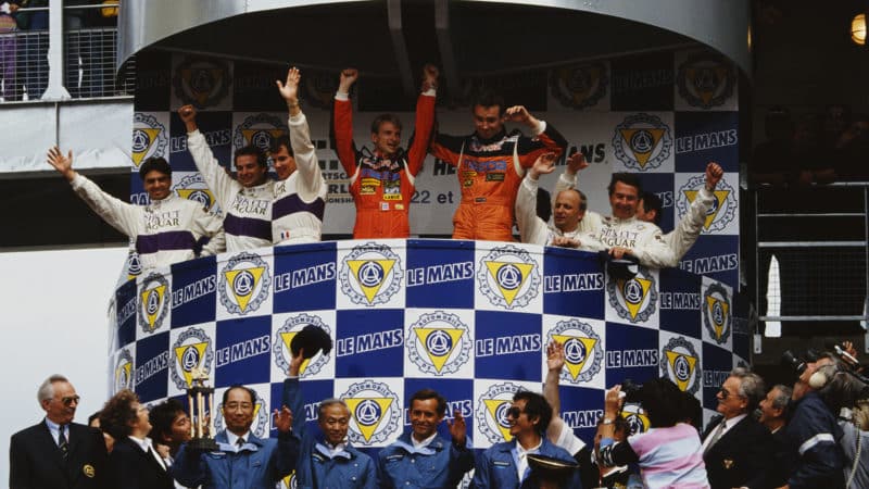 Volker Weidler of Germany and Bertrand Gachot of Belgium (orange suits centre), drivers of the #55 Mazdaspeed Mazda 787B celebrate on the podium after winning the FIA World Sportscar Championship 24 Hours of Le Mans race on 24th June 1991 at the Circuit de la Sarthe, Le Mans, France. (Photo by Pascal Rondeau/Getty Images)