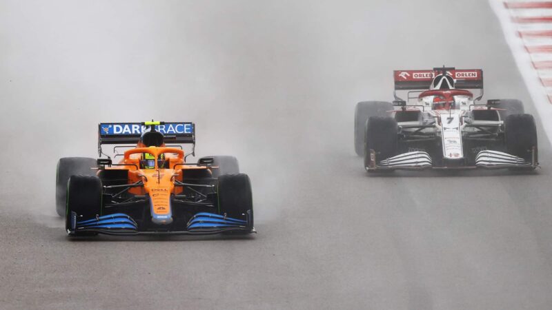 Lando Norris goes past Kimi Raikkonen in the rain at the 2021 Russian Grand Prix