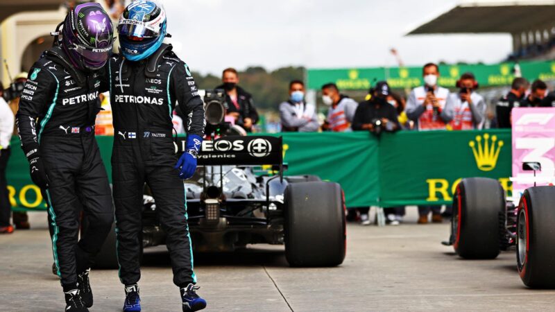 Lewis Hamilton puts his arm round Valtteri Bottas