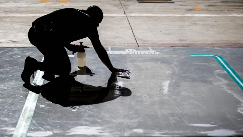 Mercedes Mechanic cleans the garage floor