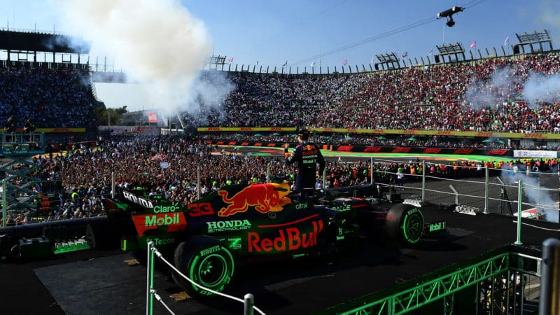 Max Verstappen and his red Bull car on the podium at the 2021 Mexican Grand Prix