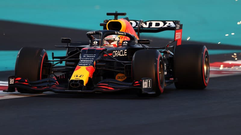 ABU DHABI, UNITED ARAB EMIRATES - DECEMBER 11: Sparks fly behind Max Verstappen of the Netherlands driving the (33) Red Bull Racing RB16B Honda during qualifying ahead of the F1 Grand Prix of Abu Dhabi at Yas Marina Circuit on December 11, 2021 in Abu Dhabi, United Arab Emirates. (Photo by Lars Baron/Getty Images)